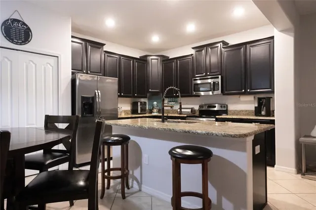 a living room with furniture kitchen view and a flat screen tv