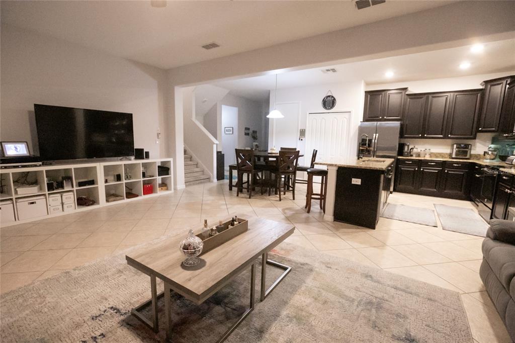 1185 Seburn Road Apopka, FL 32703 - Photo 25 of 47 a living room with furniture kitchen view and a flat screen tv