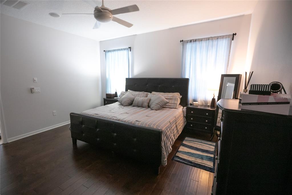 1185 Seburn Road Apopka, FL 32703 - Photo 27 of 47 a bedroom with a bed and a chandelier fan