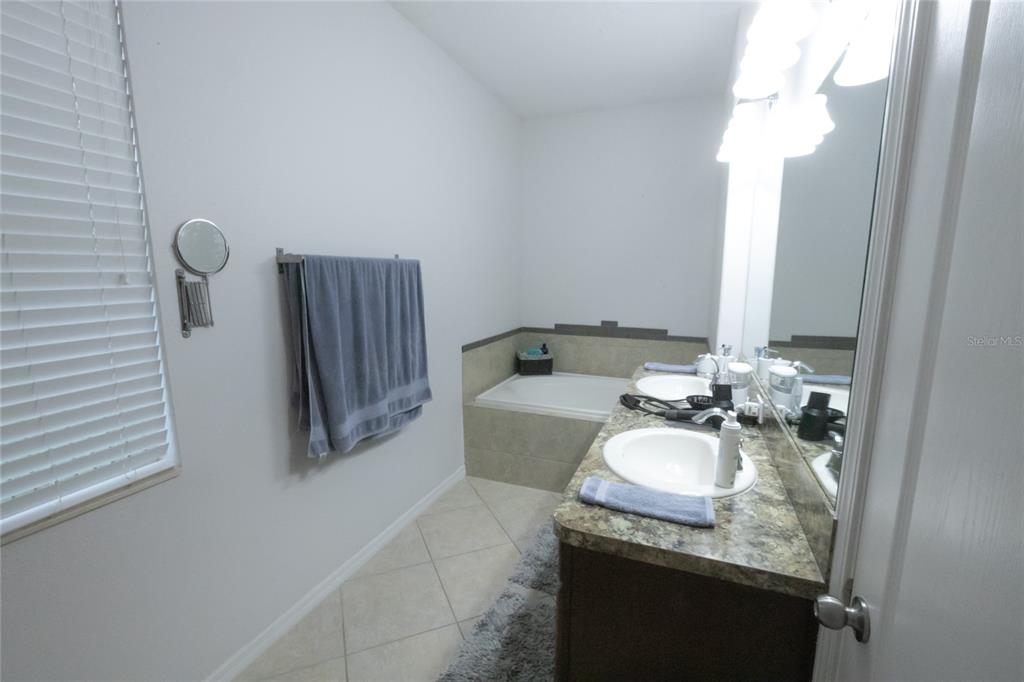 1185 Seburn Road Apopka, FL 32703 - Photo 29 of 47 a bathroom with a granite countertop sink and a mirror