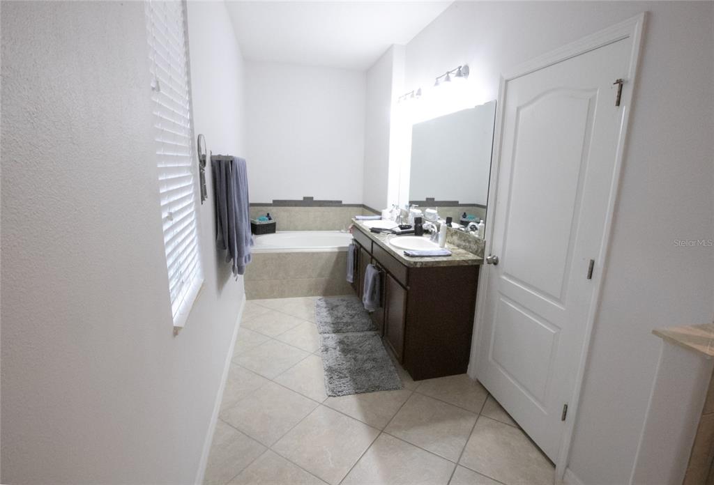 1185 Seburn Road Apopka, FL 32703 - Photo 30 of 47 a bathroom with a sink a toilet and mirror