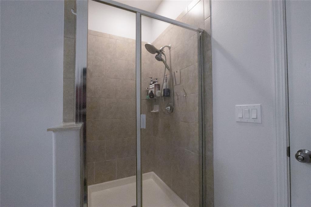 1185 Seburn Road Apopka, FL 32703 - Photo 31 of 47 a bathroom with a glass shower door