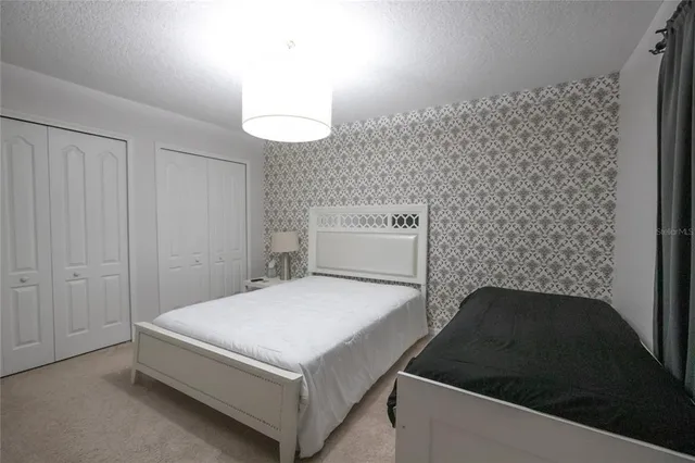 a bathroom with a sink toilet a mirror and shower