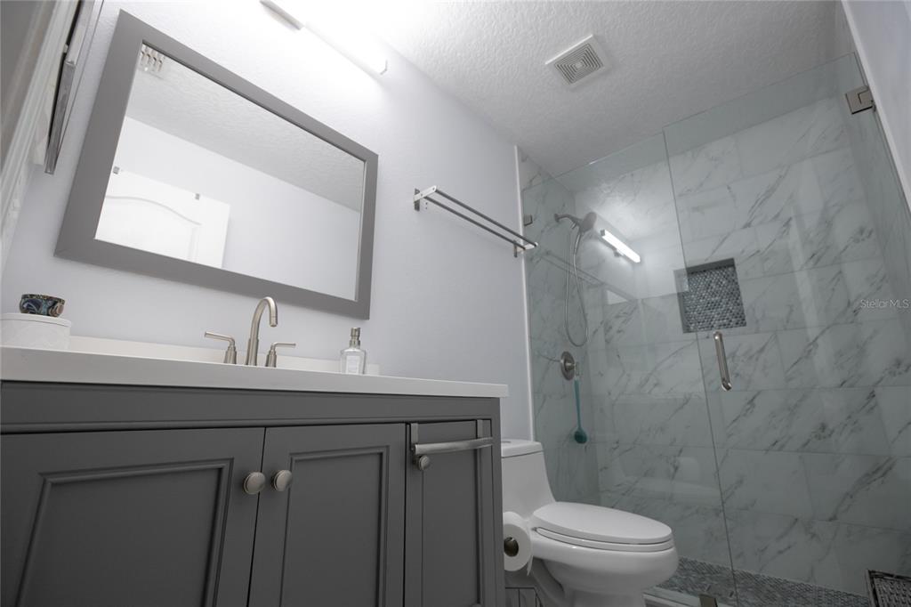 1185 Seburn Road Apopka, FL 32703 - Photo 35 of 47 a bathroom with a sink toilet a mirror and shower