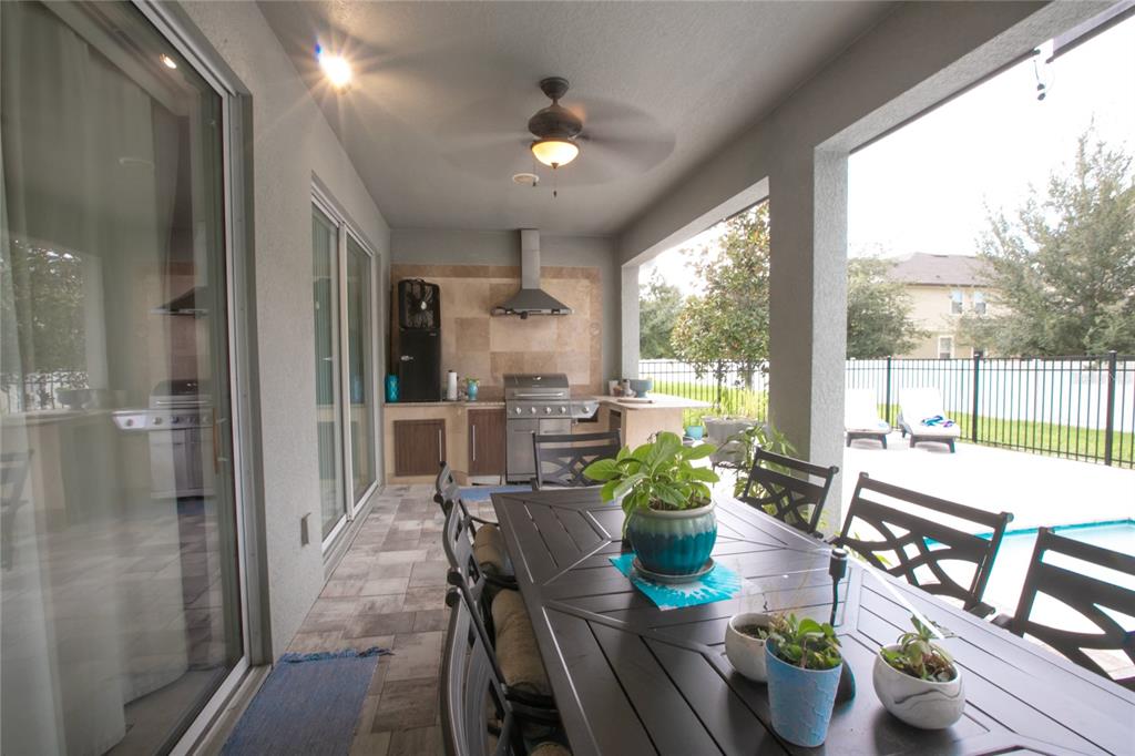 1185 Seburn Road Apopka, FL 32703 - Photo 40 of 47 a dining room with furniture a potted plant and wooden floor