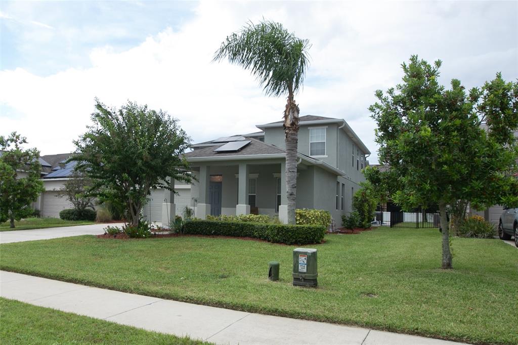 1185 Seburn Road Apopka, FL 32703 - Photo 4 of 47 a front view of a house with a garden and trees