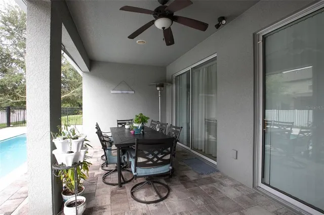 a view of a patio with table and chairs and potted plants