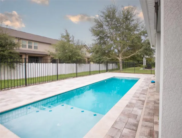 a view of a swimming pool with a backyard