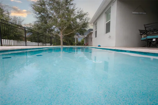 a view of a swimming pool with a backyard