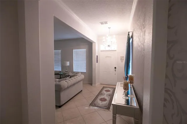 a view of a dining room with furniture and a chandelier