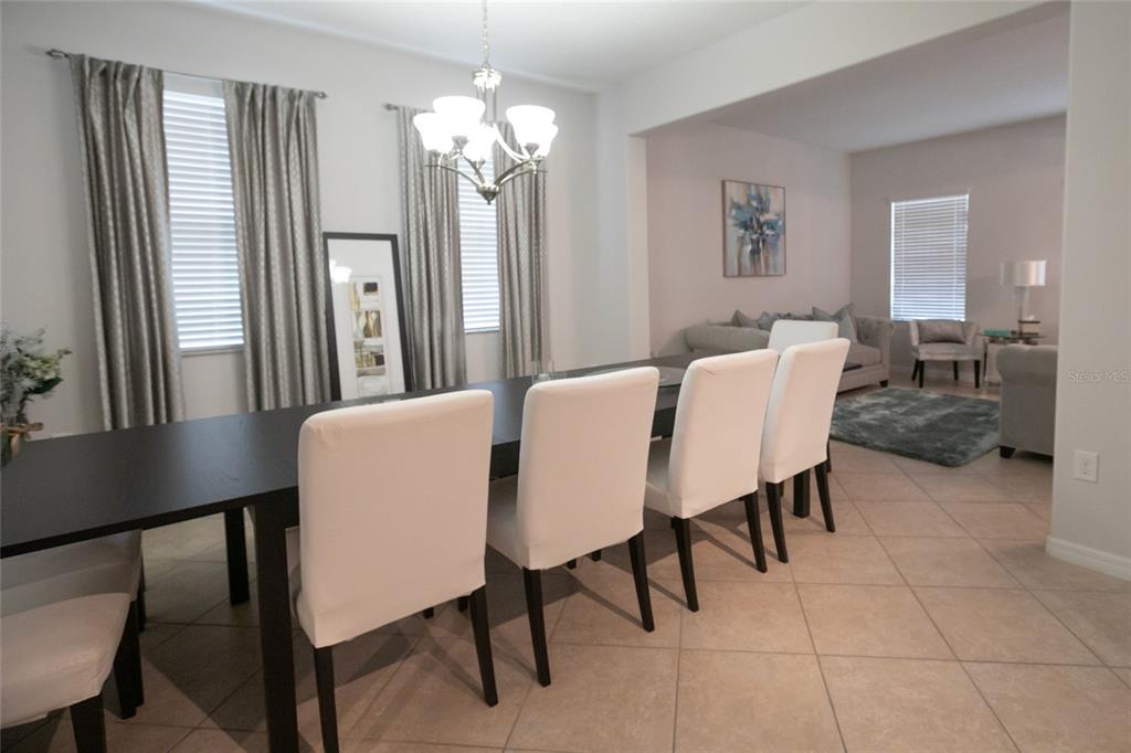 1185 Seburn Road Apopka, FL 32703 - Photo 10 of 47 a view of a dining room with furniture and a chandelier