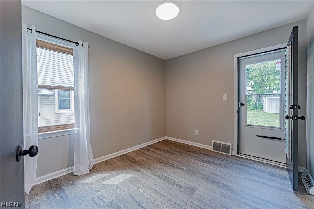 11815 Derby Road Garfield Heights, OH 44125 - Photo 12 of 31 Spare room with light, LVP floors