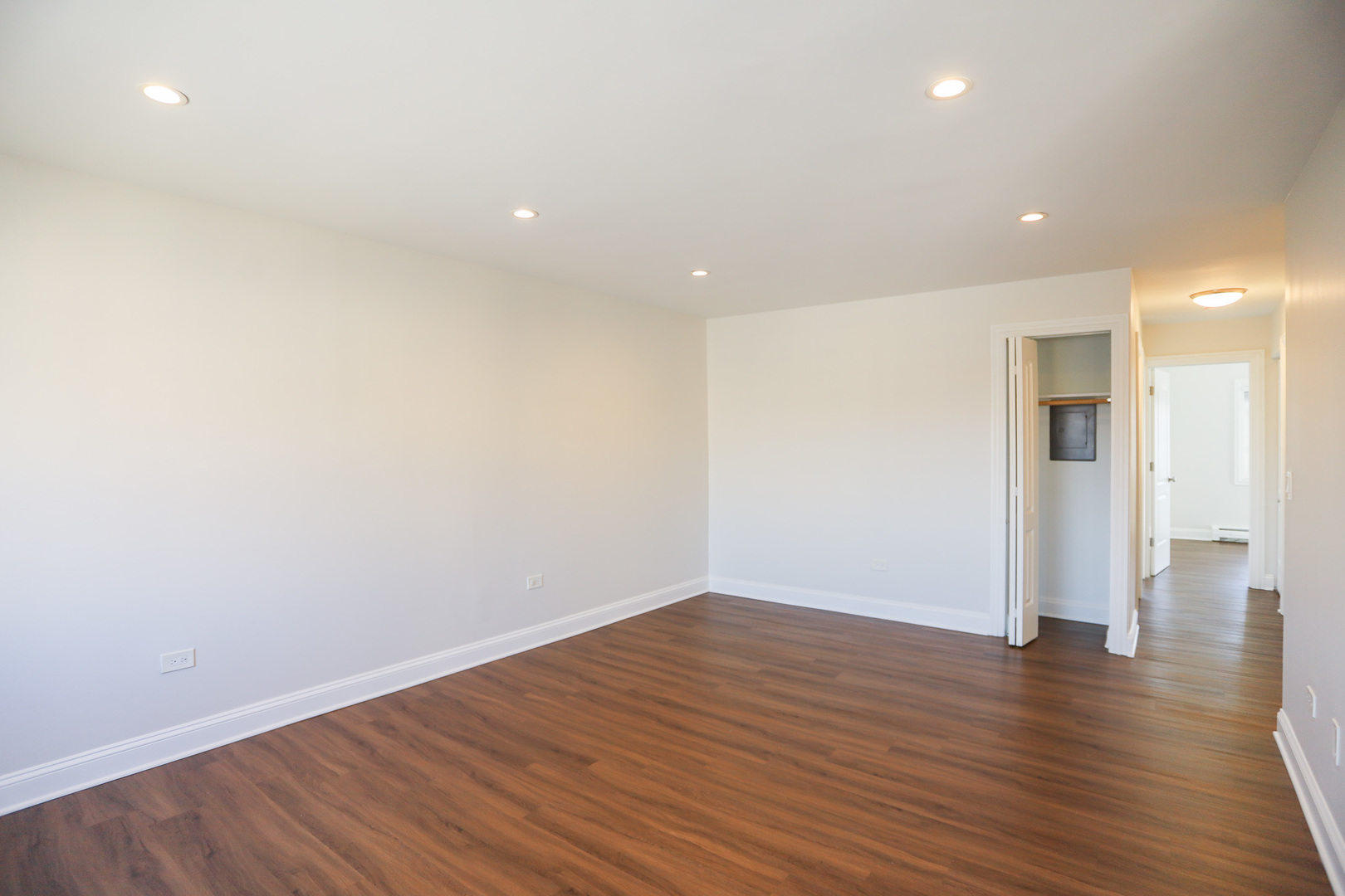8651 West Foster Avenue, Unit 3A Chicago, IL 60656 - Photo 12 of 17 a view of an empty room with wooden floor and a window