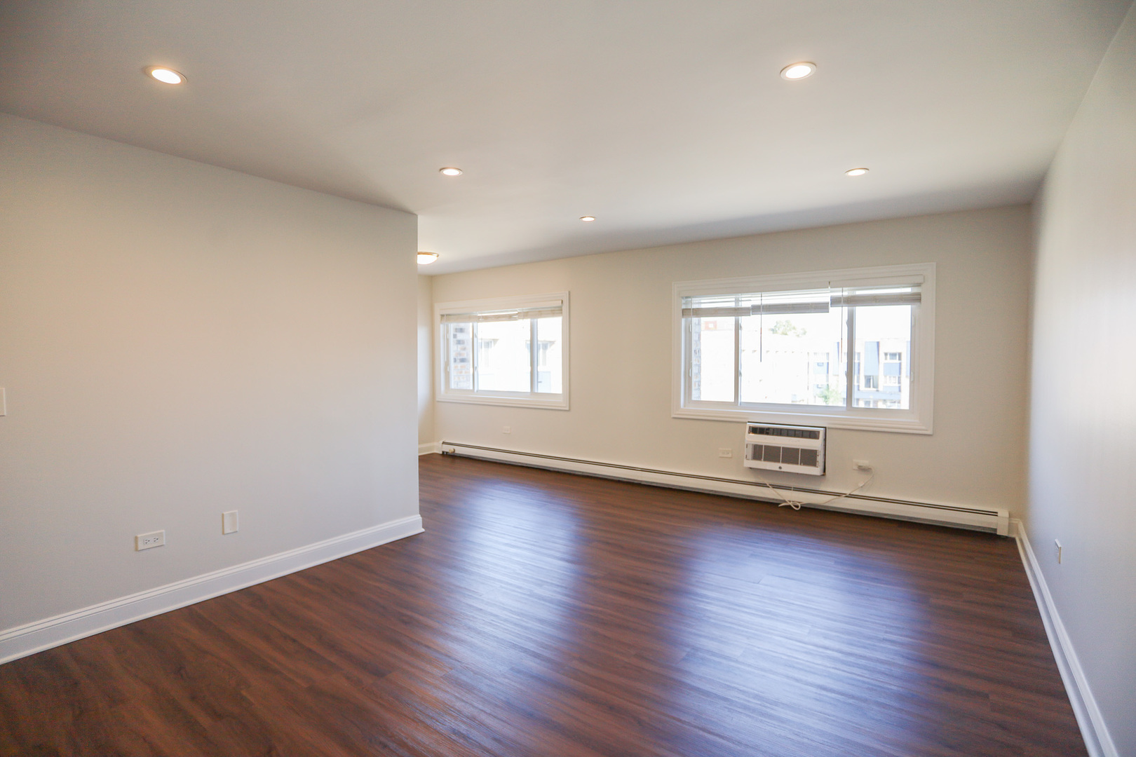 8651 West Foster Avenue, Unit 3A Chicago, IL 60656 - Photo 15 of 17 a view of empty room with wooden floor and fan
