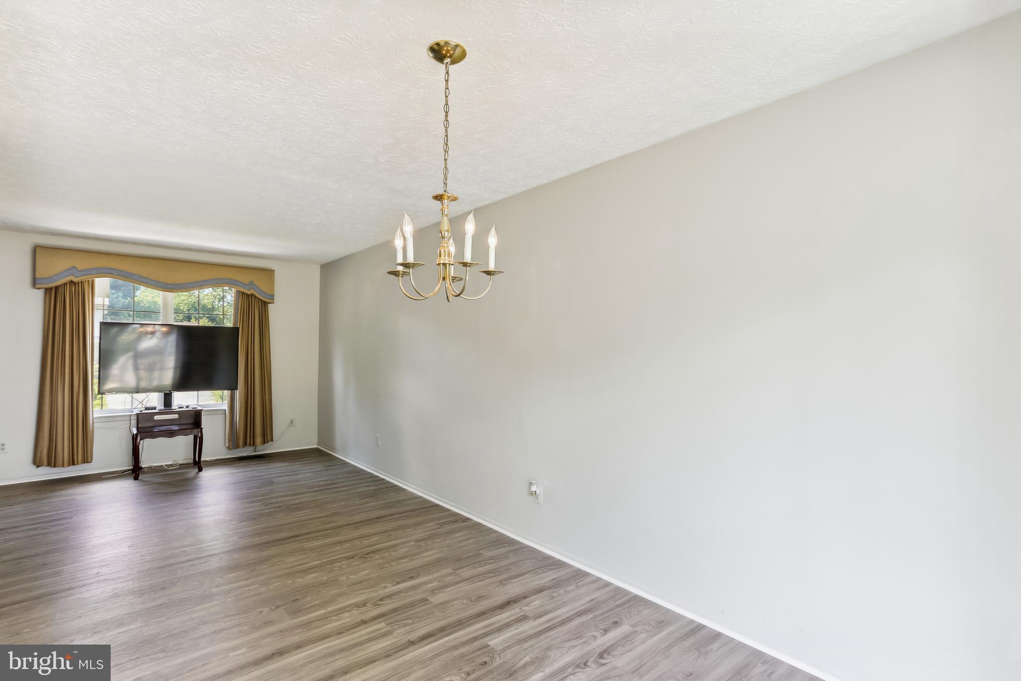 8225 Grainfield Road Severn, MD 21144 - Photo 10 of 35 a view of a room with wooden floor table and chairs