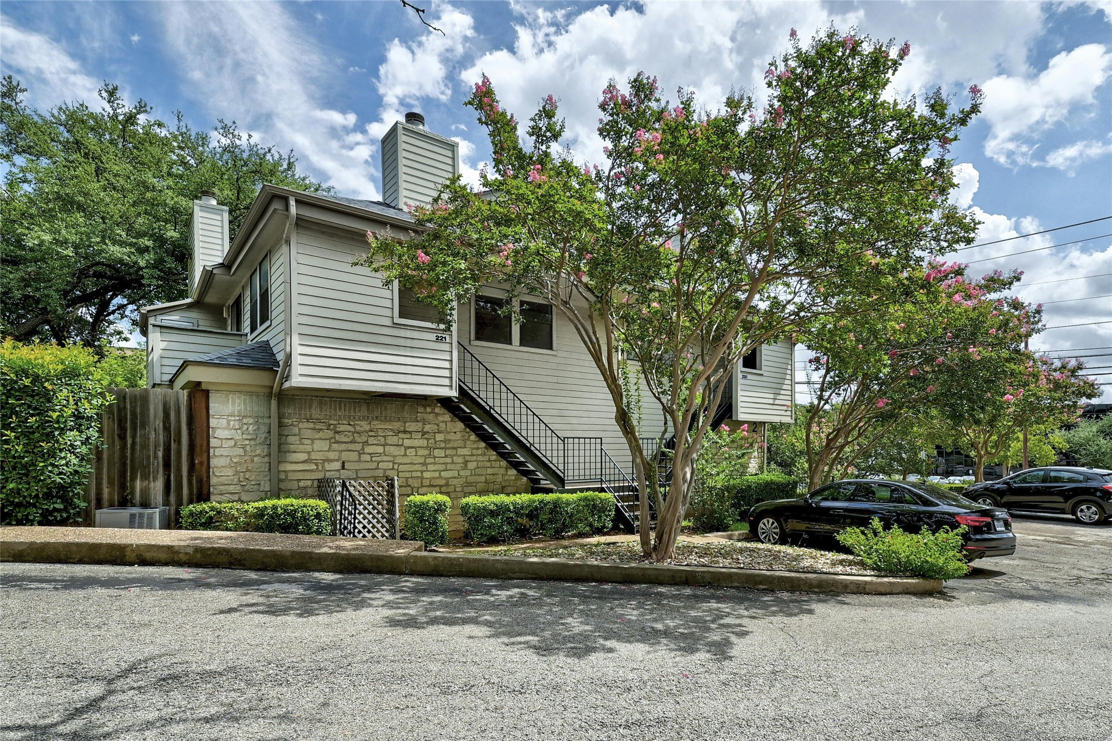 9226 Jollyville Road, Unit 221 Austin, TX 78759 - Photo 3 of 20 Board and batten siding with stone accents creates a distinctive facade.