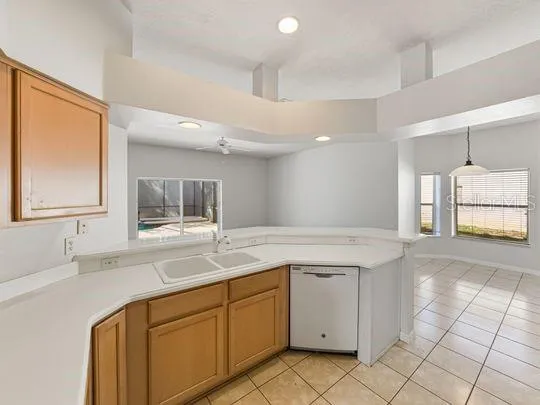 a living room with a sink and a refrigerator