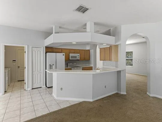 a kitchen with a stove a refrigerator and a sink