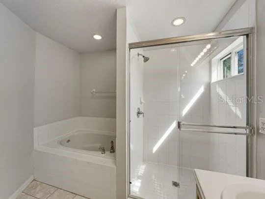 a spacious bathroom with a sink a mirror and a bathtub