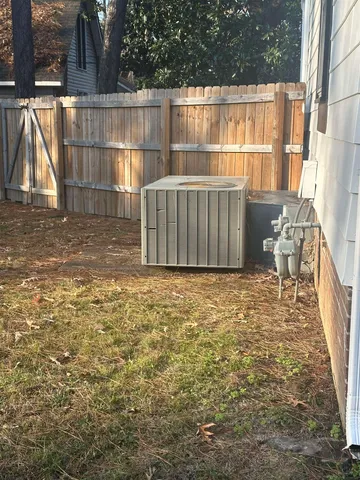 a view of a backyard with wooden fence
