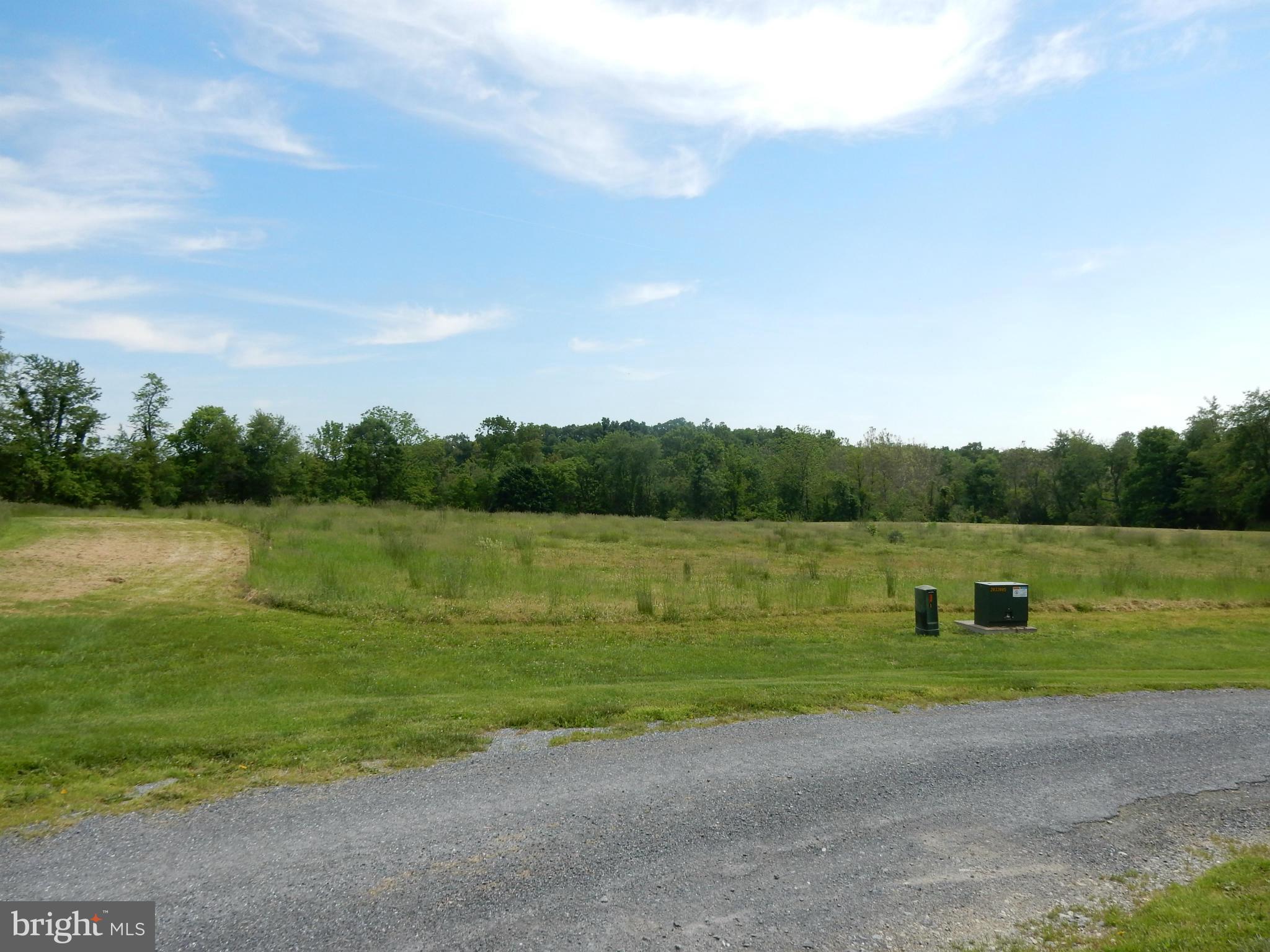 9547 Liberty Road Frederick, MD 21701 - Photo 3 of 18 a view of a lake with green field