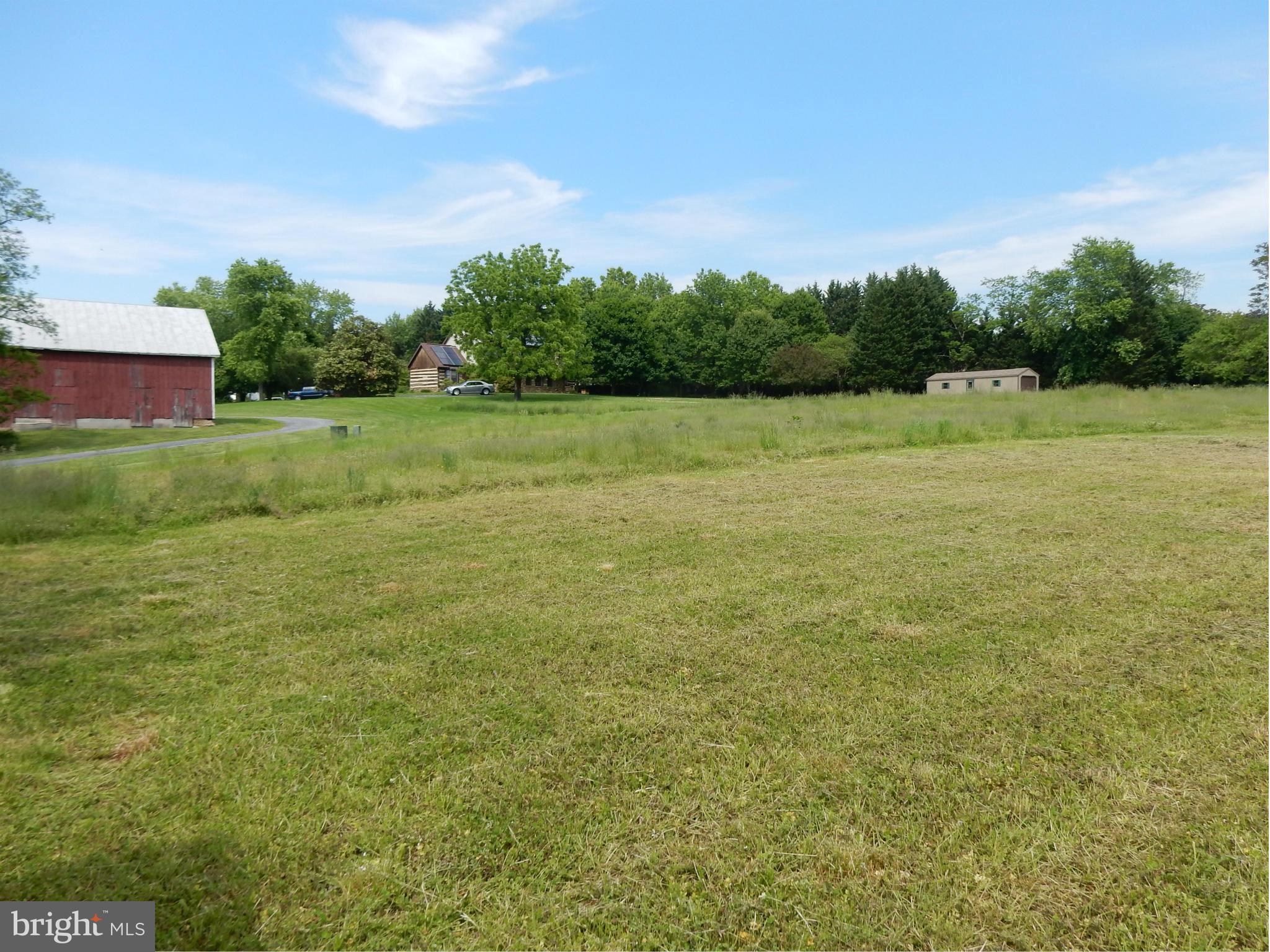 9547 Liberty Road Frederick, MD 21701 - Photo 8 of 18 a view of a green field with wooden fence