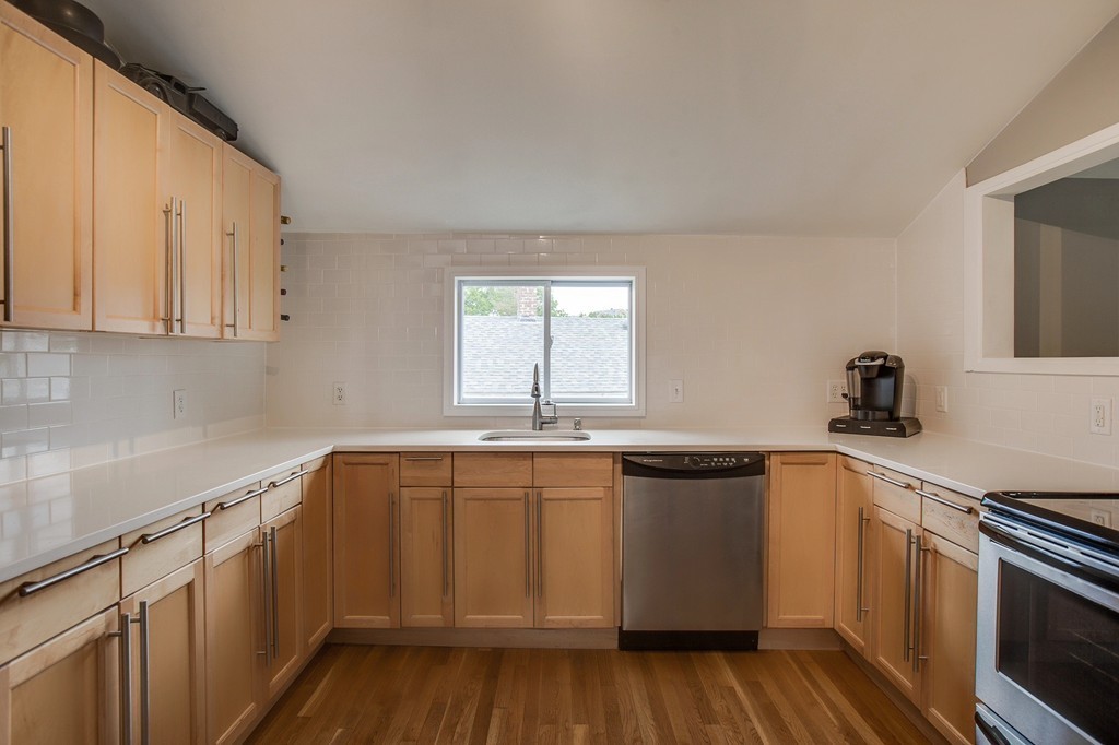 93 Hardy Pond Road Waltham, MA 02451 - Photo 7 of 29 a kitchen with a sink and cabinets