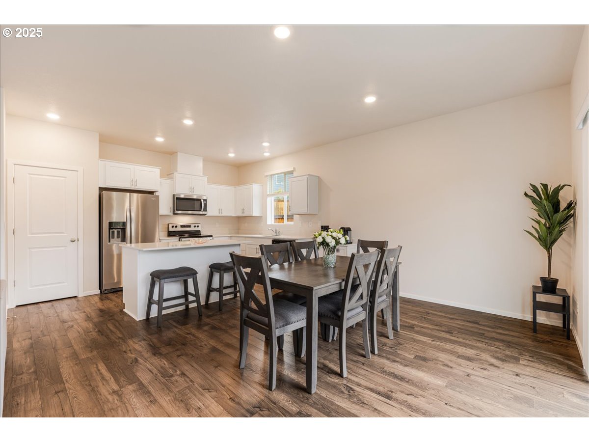 3499 Southeast Paropa Avenue Gresham, OR 97080 - Photo 14 of 48 a view of a dining room with furniture and wooden floor