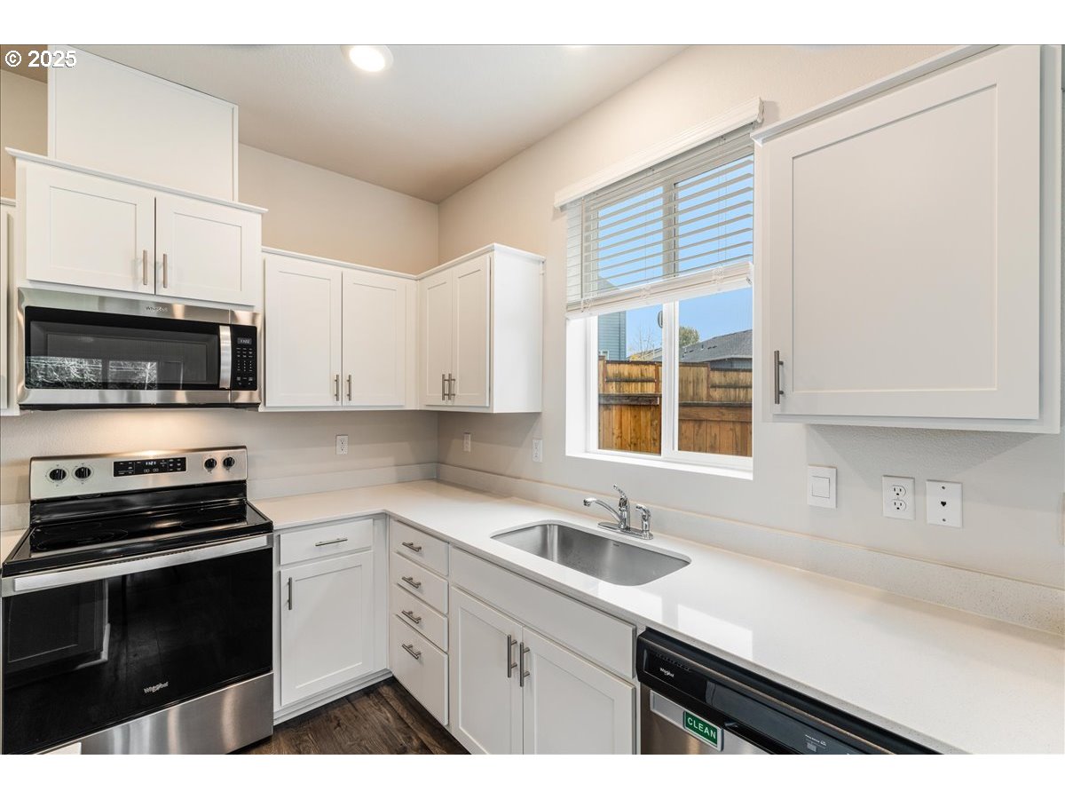 3499 Southeast Paropa Avenue Gresham, OR 97080 - Photo 21 of 48 a kitchen with stainless steel appliances a sink stove and microwave