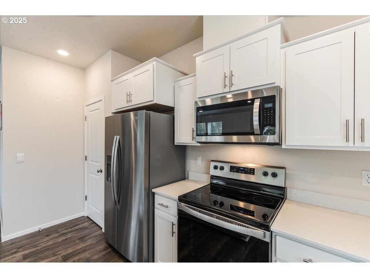 3499 Southeast Paropa Avenue Gresham, OR 97080 - Photo 22 of 48 a kitchen with stainless steel appliances a refrigerator a stove a microwave and cabinets
