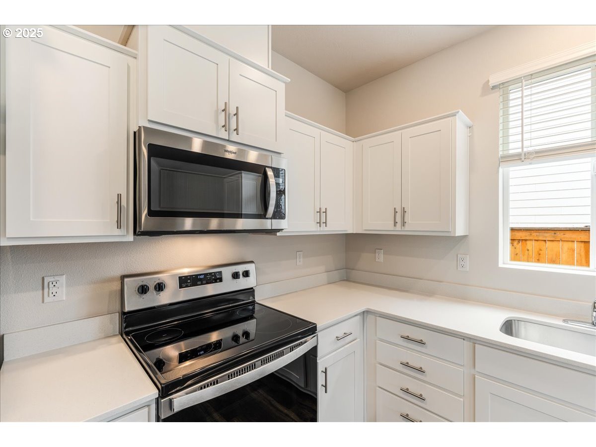 3499 Southeast Paropa Avenue Gresham, OR 97080 - Photo 23 of 48 a kitchen with cabinets stainless steel appliances and a window