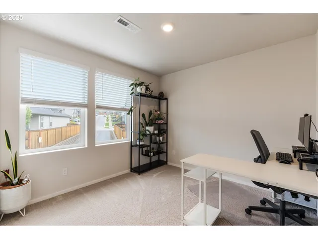 a bedroom with a bed window and a night stand