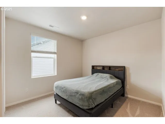 a living room with a bed and a window