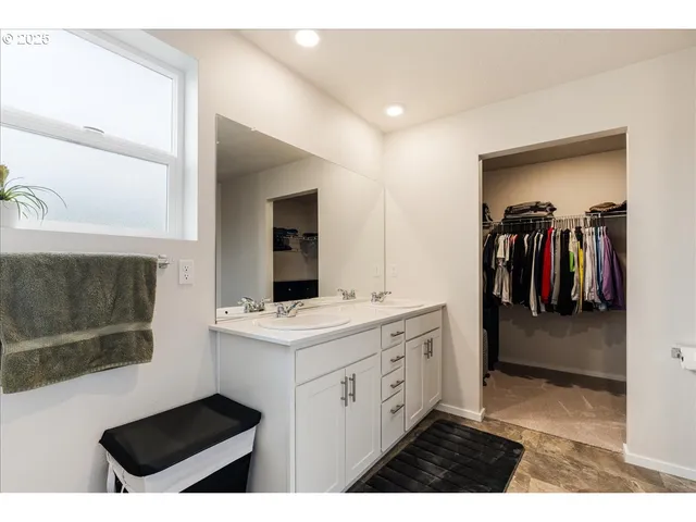 a view of walk in closet with clothes