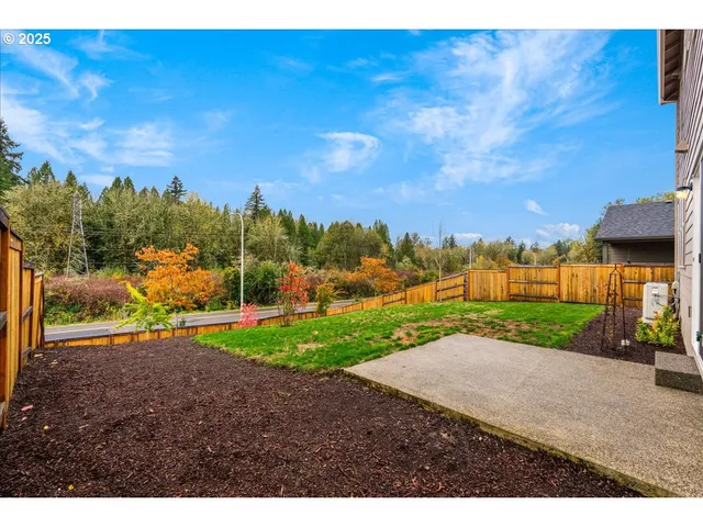 a view of a house with backyard and a garden