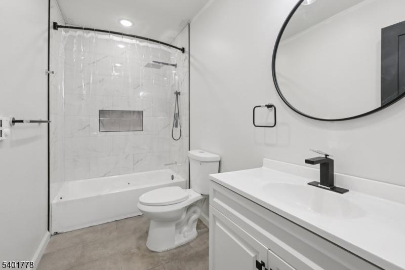 540 East 25th Street Paterson, NJ 07514 - Photo 5 of 10 a bathroom with a sink a toilet and a mirror
