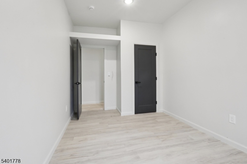 540 East 25th Street Paterson, NJ 07514 - Photo 7 of 10 a view of a hallway with wooden floor