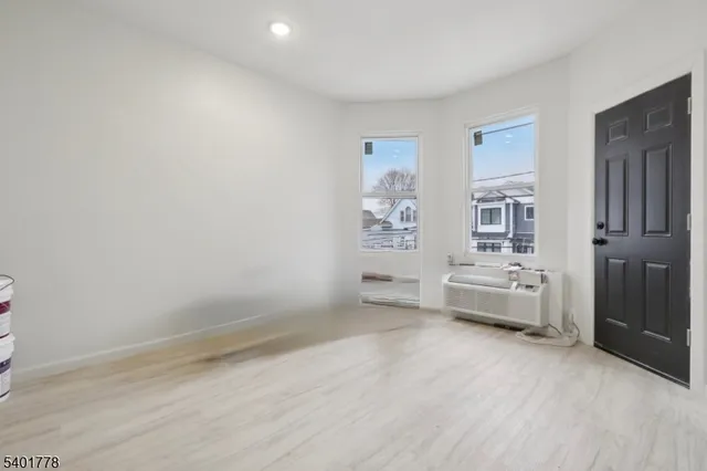 an empty room with furniture and window