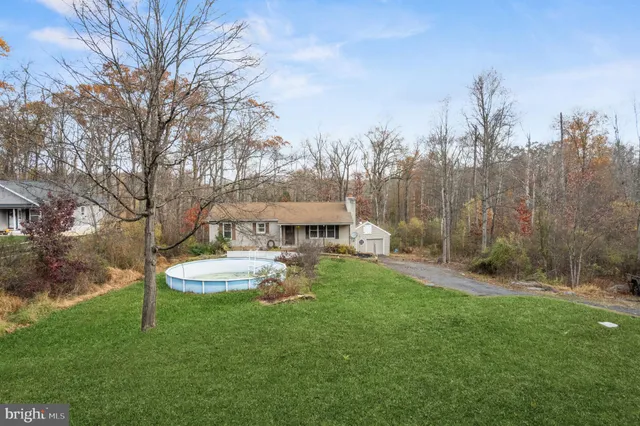 a view of a house with a yard table and chairs