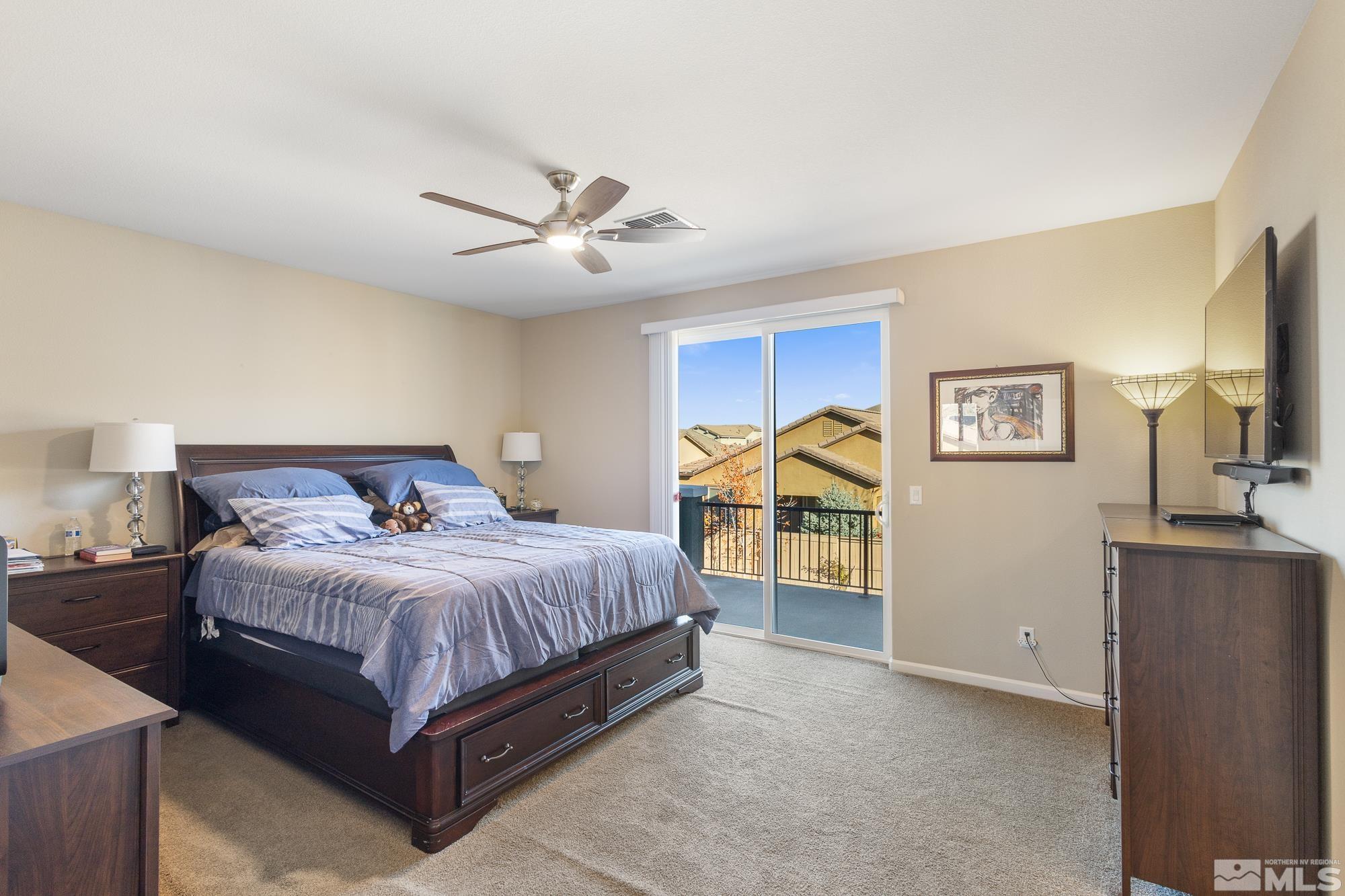2875 Bonfire Lane Reno, NV 89521 - Photo 16 of 39 a bedroom with a bed and a flat tv screen on dresser