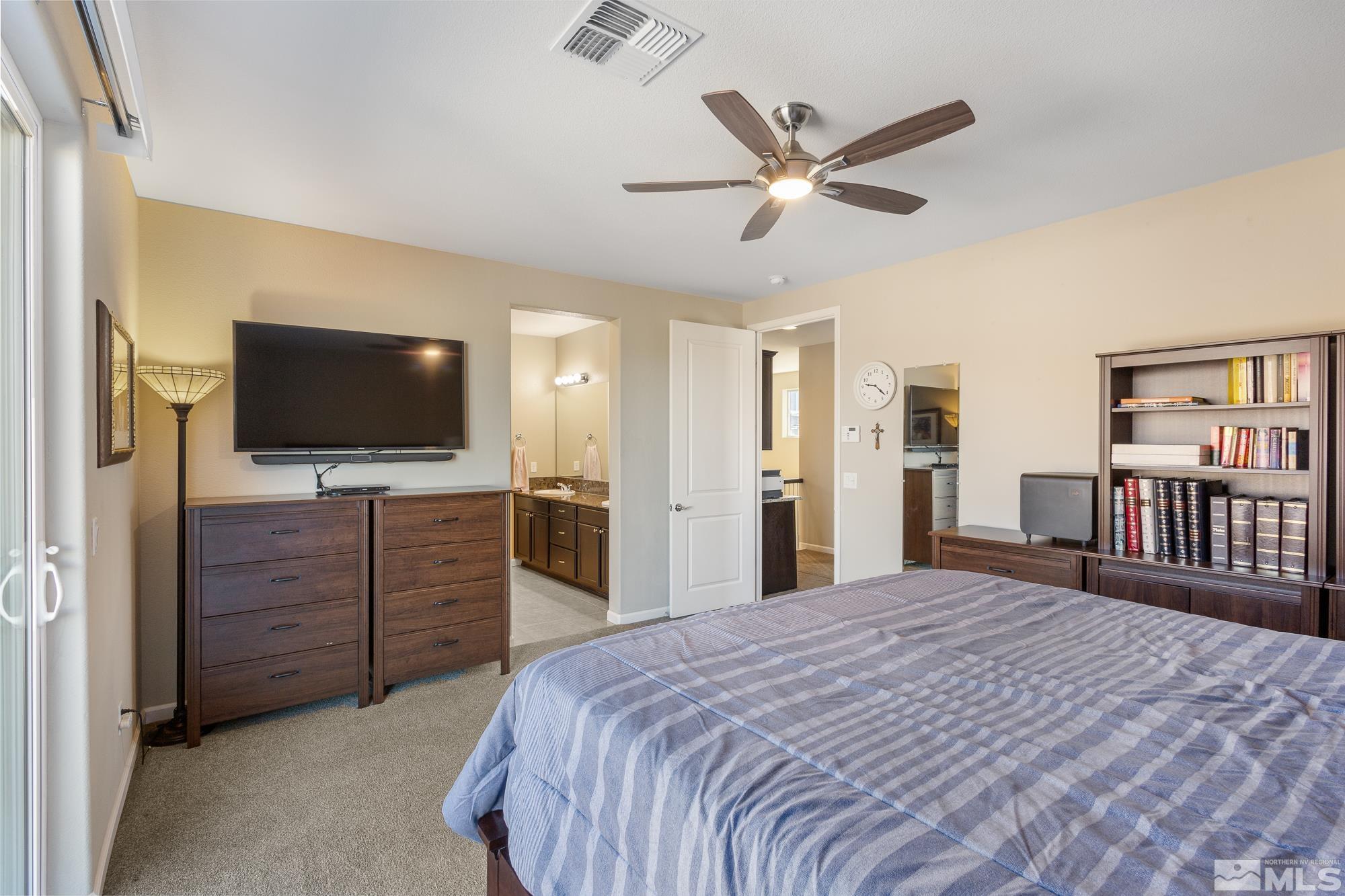 2875 Bonfire Lane Reno, NV 89521 - Photo 17 of 39 a bedroom with a bed and a flat screen tv