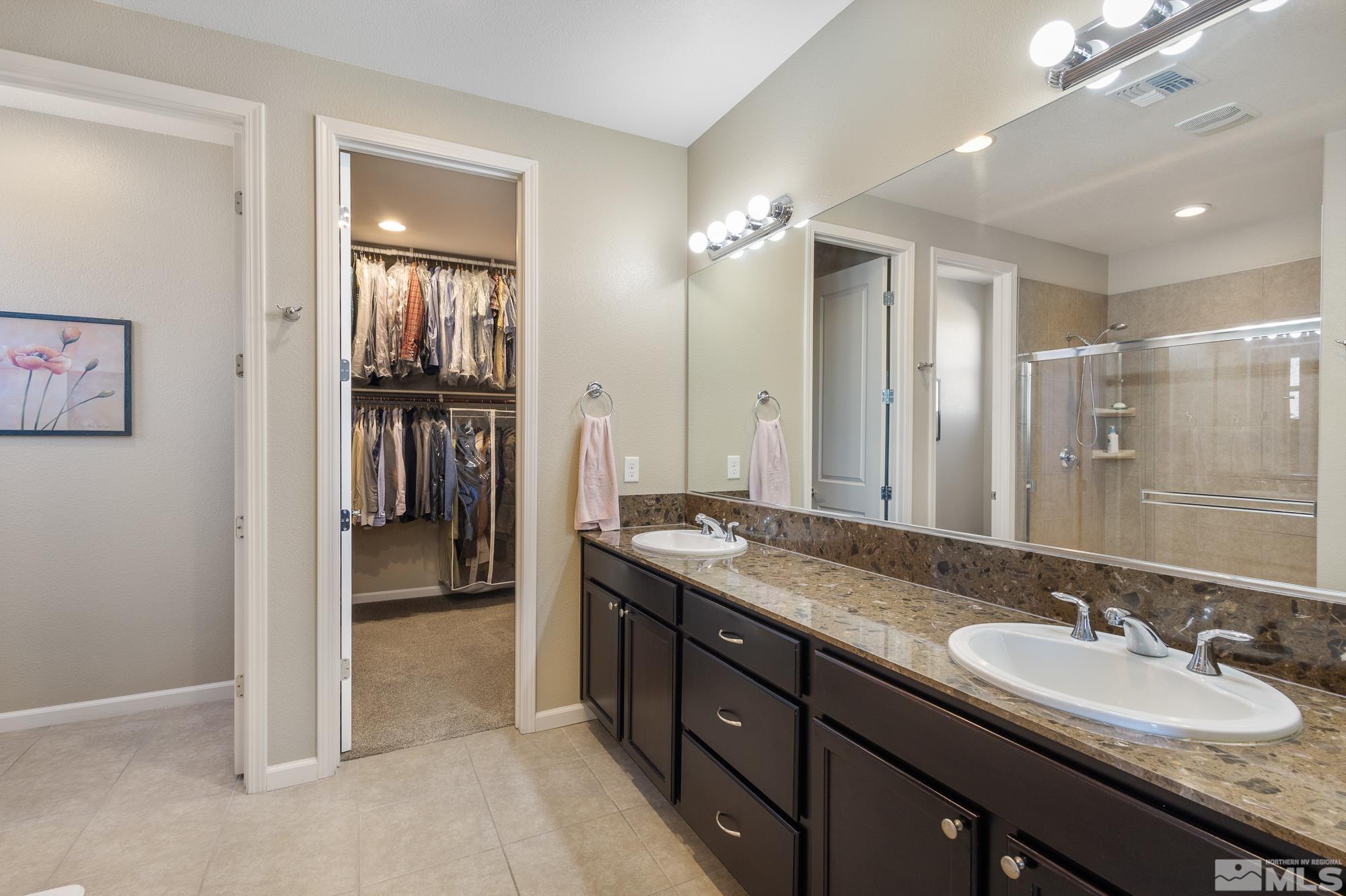 2875 Bonfire Lane Reno, NV 89521 - Photo 18 of 39 a spacious bathroom with a granite countertop sink a mirror and a shower