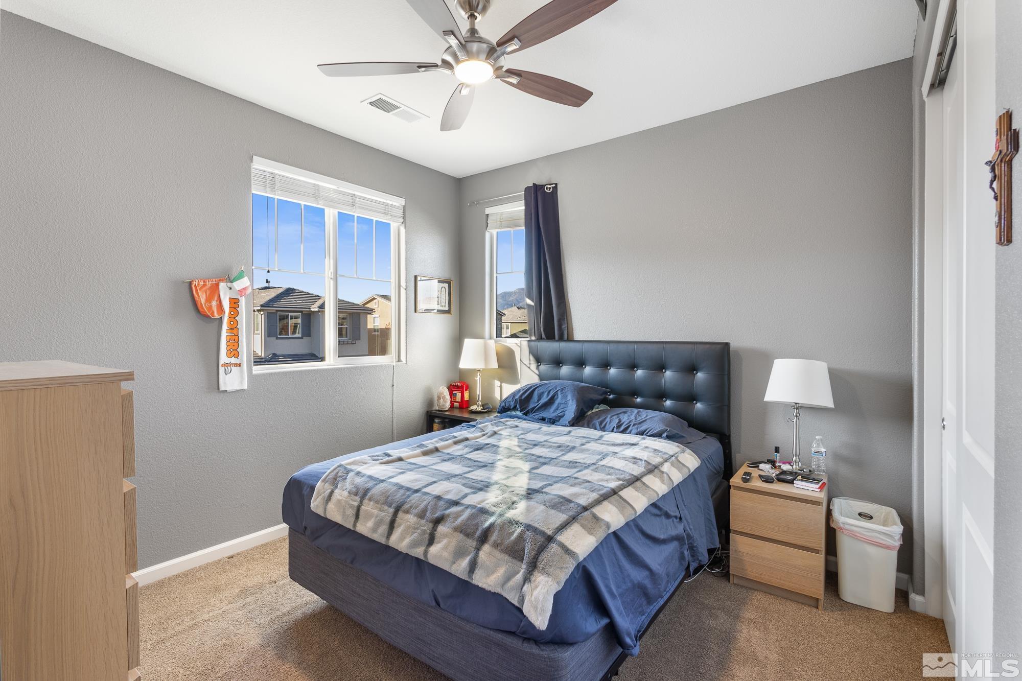 2875 Bonfire Lane Reno, NV 89521 - Photo 23 of 39 a bedroom with a bed and a chandelier