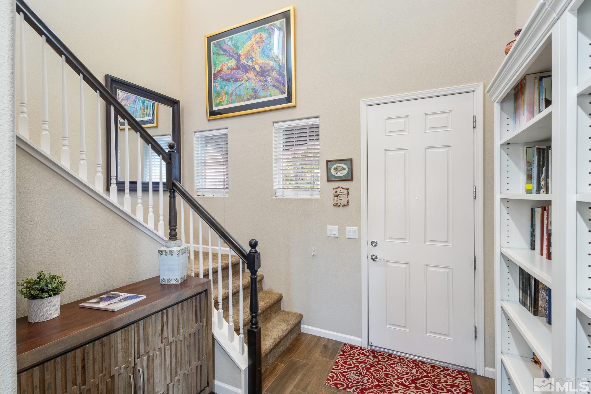 2875 Bonfire Lane Reno, NV 89521 - Photo 4 of 39 a view of staircase with lots of frames on wall and a painting on the wall
