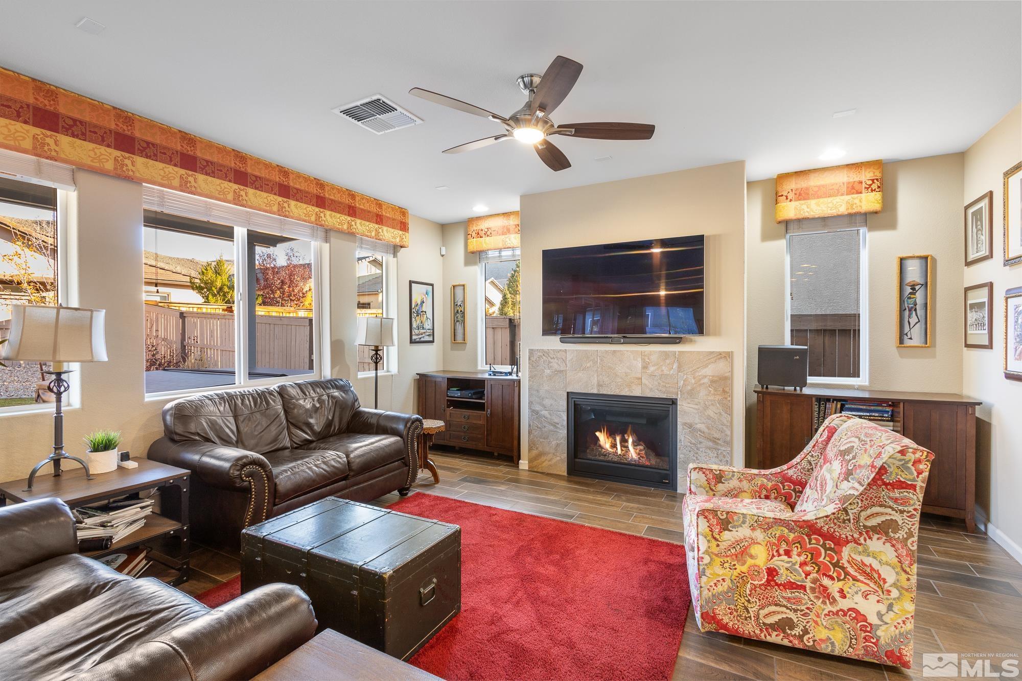 2875 Bonfire Lane Reno, NV 89521 - Photo 6 of 39 a living room with furniture fireplace and a flat screen tv