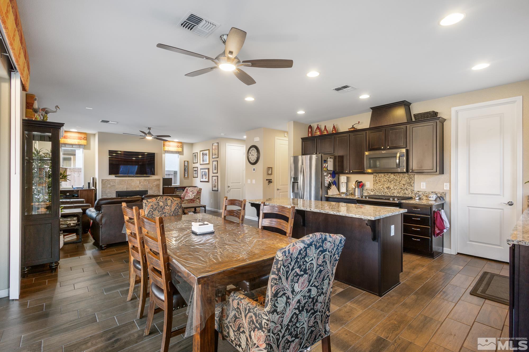2875 Bonfire Lane Reno, NV 89521 - Photo 8 of 39 a view of a dining room with furniture and wooden floor