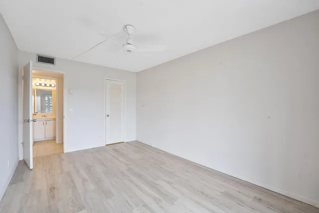 a bathroom with a toilet sink vanity and mirror