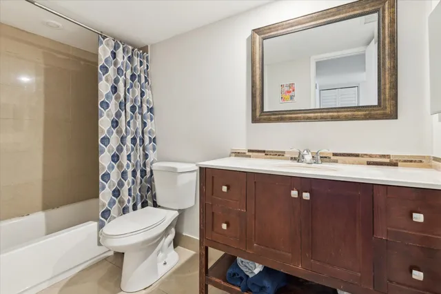 a bathroom with a toilet a sink and a mirror