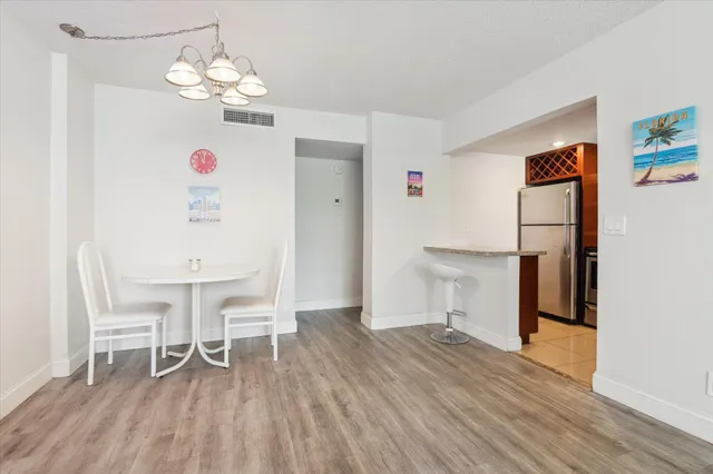 a view of a dining room with furniture wooden floor and a chandelier
