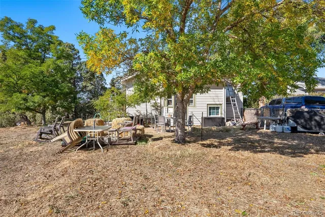 a backyard of a house with table and chairs